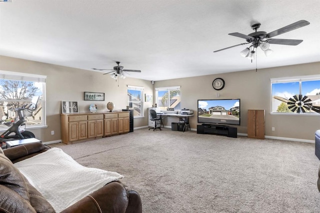 carpeted living room featuring a healthy amount of sunlight and ceiling fan