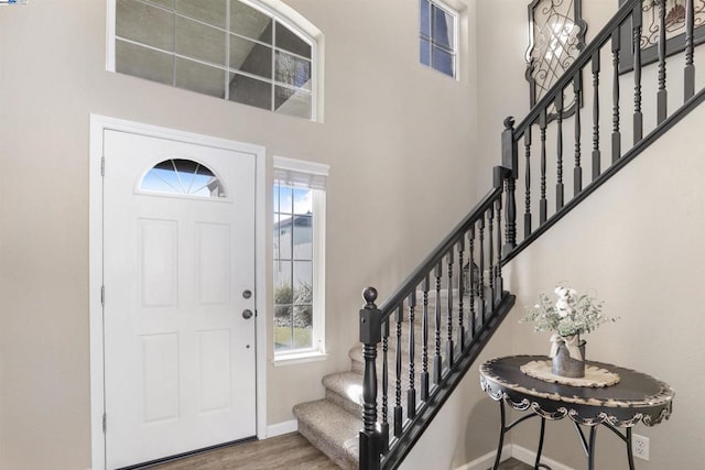 entrance foyer featuring an inviting chandelier and wood-type flooring