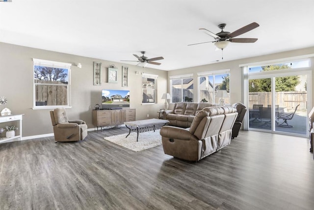 living room with dark hardwood / wood-style flooring and ceiling fan