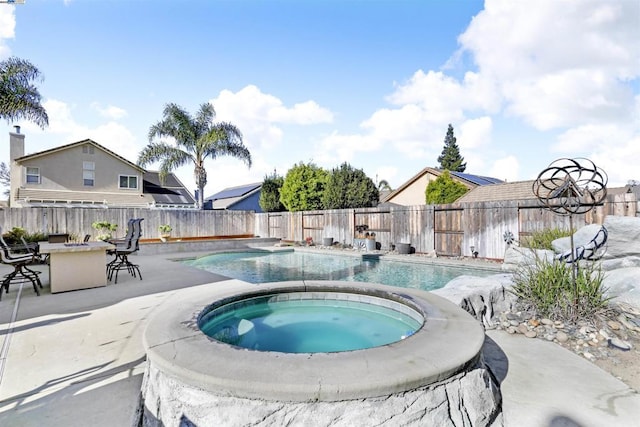 view of swimming pool with a bar and an in ground hot tub