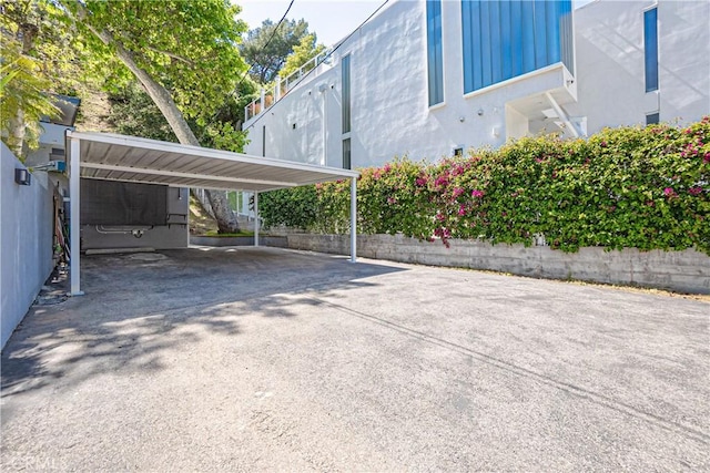 view of vehicle parking with a carport