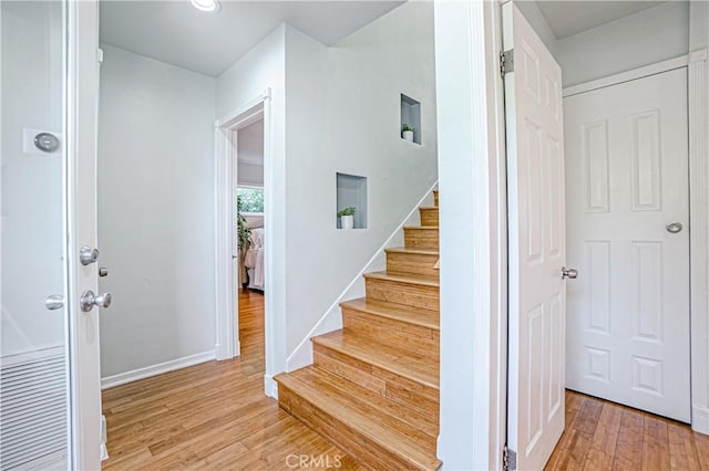 staircase with hardwood / wood-style flooring