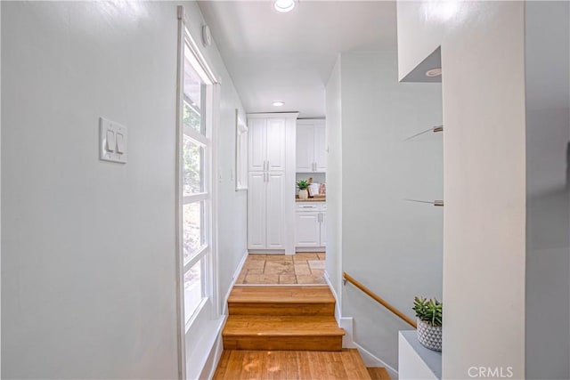 staircase with hardwood / wood-style flooring