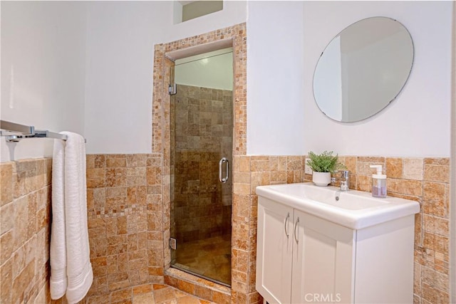 bathroom featuring vanity, tile walls, and walk in shower