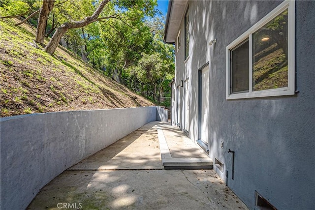 view of side of home with a patio