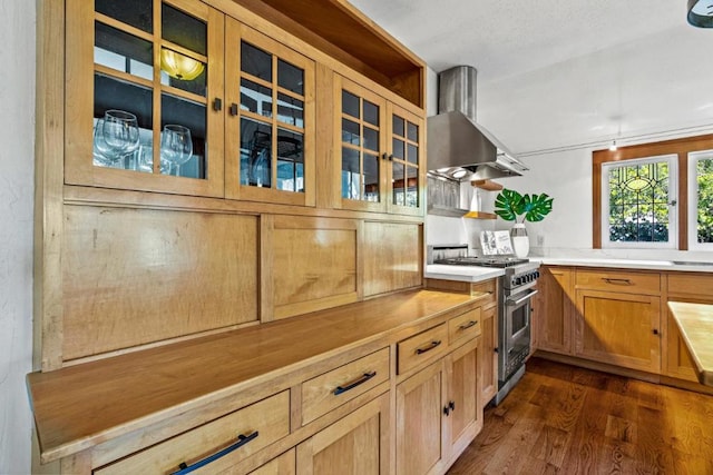 kitchen featuring dark hardwood / wood-style flooring, high end range, and wall chimney exhaust hood