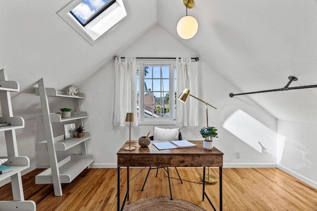 office space featuring lofted ceiling with skylight and wood-type flooring