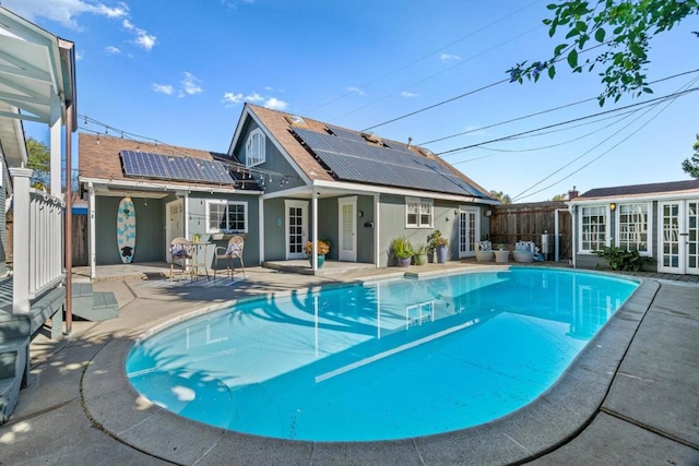 view of swimming pool with french doors and a patio area