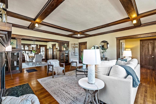 living room with coffered ceiling, dark hardwood / wood-style floors, and beam ceiling