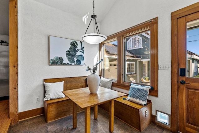 dining area featuring a healthy amount of sunlight and lofted ceiling