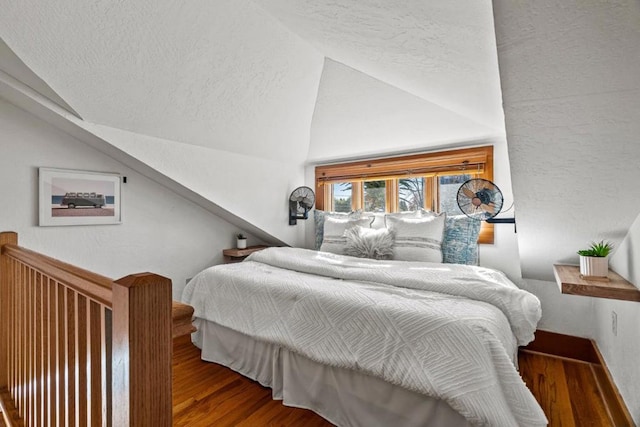 bedroom featuring vaulted ceiling and hardwood / wood-style floors