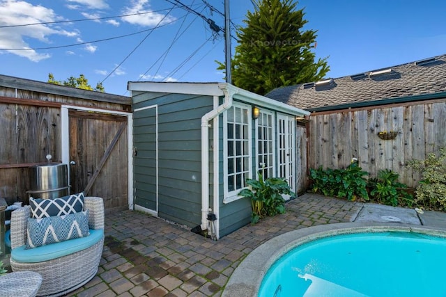 view of swimming pool featuring a storage unit