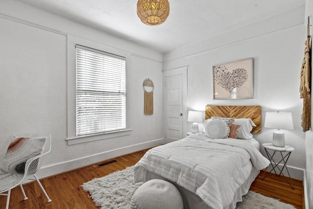 bedroom featuring multiple windows and hardwood / wood-style floors