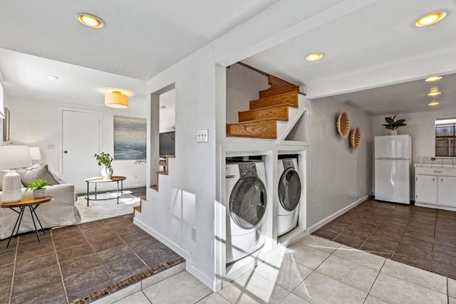 clothes washing area featuring separate washer and dryer and tile patterned floors