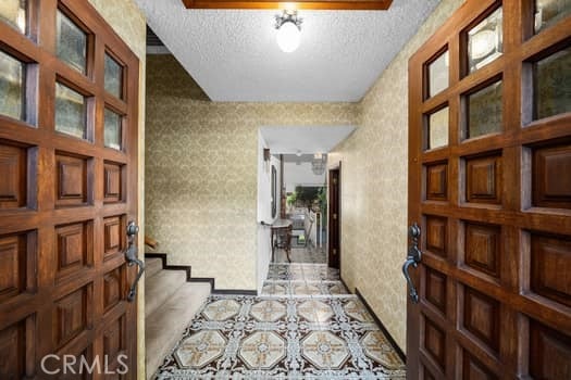 foyer with a textured ceiling