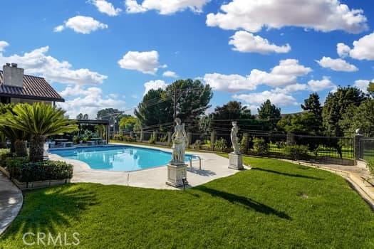 view of pool featuring a patio and a lawn