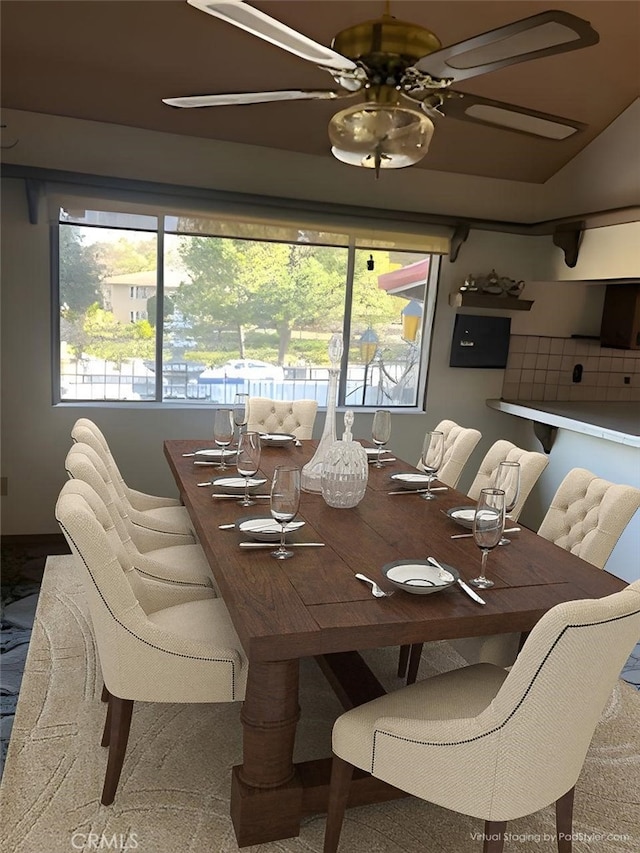 dining room featuring lofted ceiling and ceiling fan