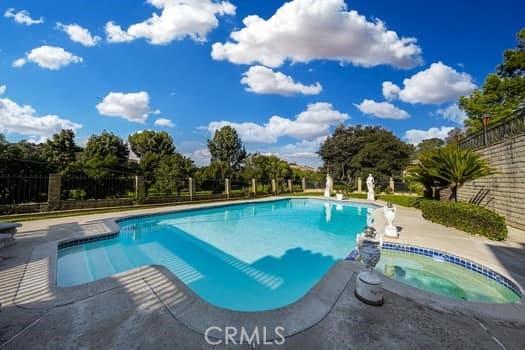 view of swimming pool featuring an in ground hot tub