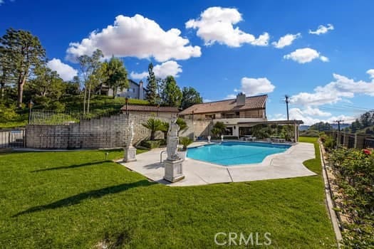 view of swimming pool with a patio area and a lawn