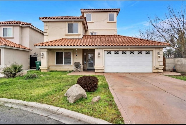 mediterranean / spanish-style house featuring a garage and a front lawn