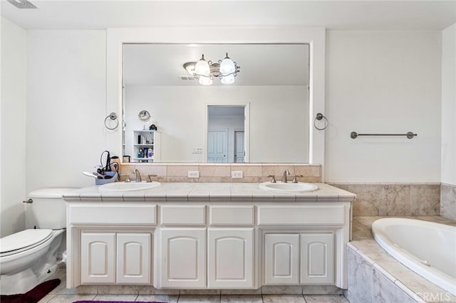 bathroom featuring toilet, tile patterned flooring, a relaxing tiled tub, and vanity