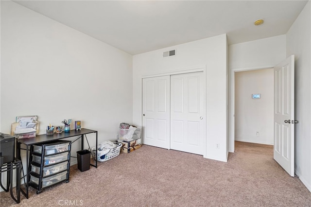 carpeted bedroom with a closet