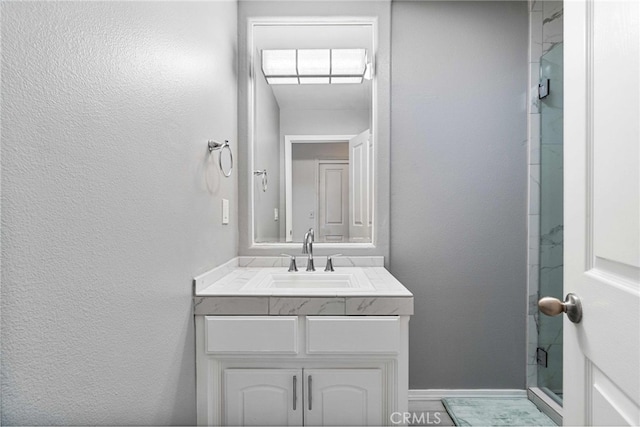 bathroom with vanity and a shower with door