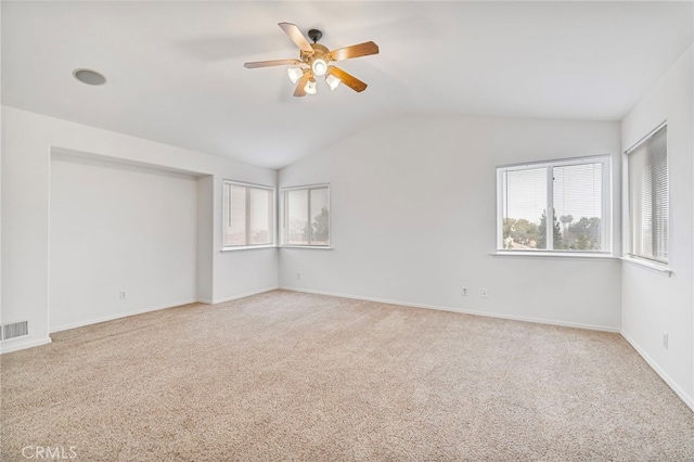 carpeted empty room with ceiling fan and vaulted ceiling