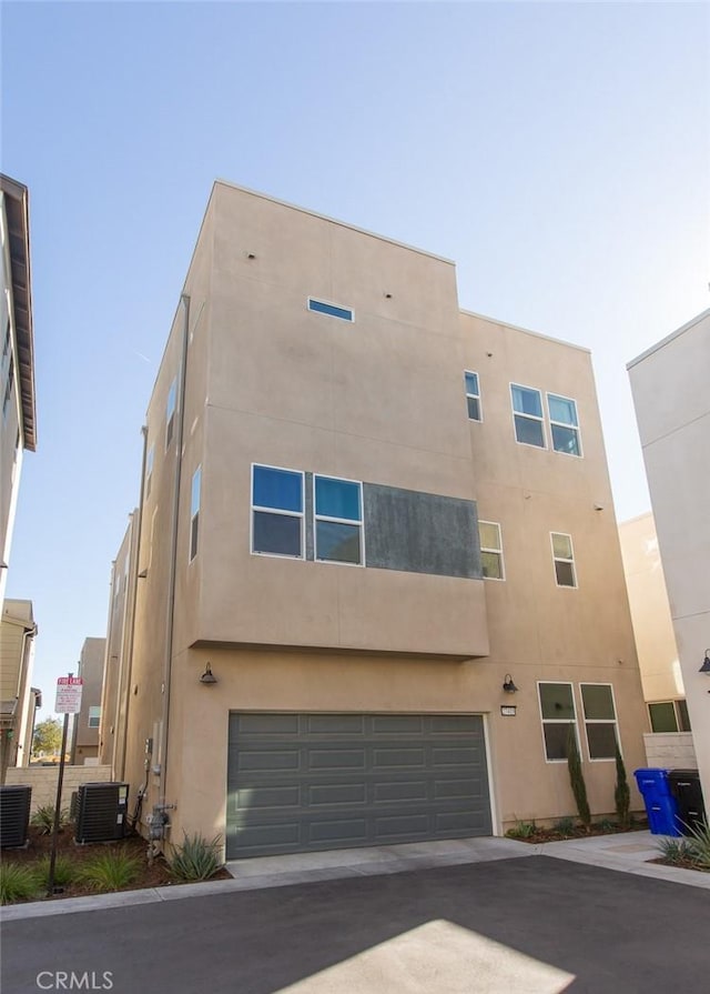 exterior space with cooling unit and a garage