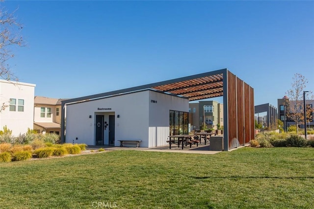 rear view of house featuring a lawn