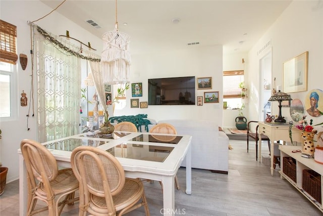 dining space with wood-type flooring