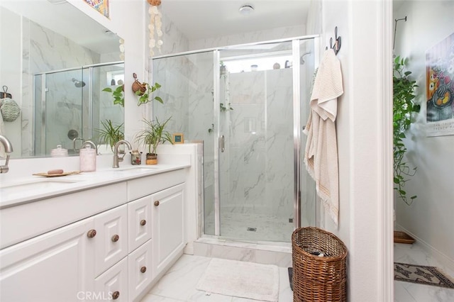 bathroom with a shower with door and vanity