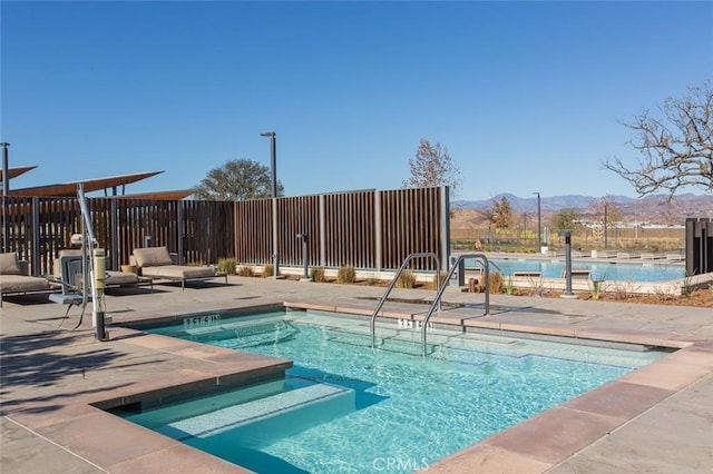 view of pool featuring a mountain view and a patio area