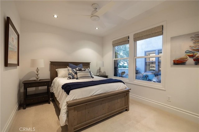 bedroom featuring light carpet and ceiling fan