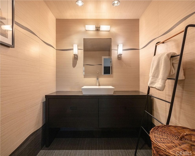 bathroom with tile walls and vanity