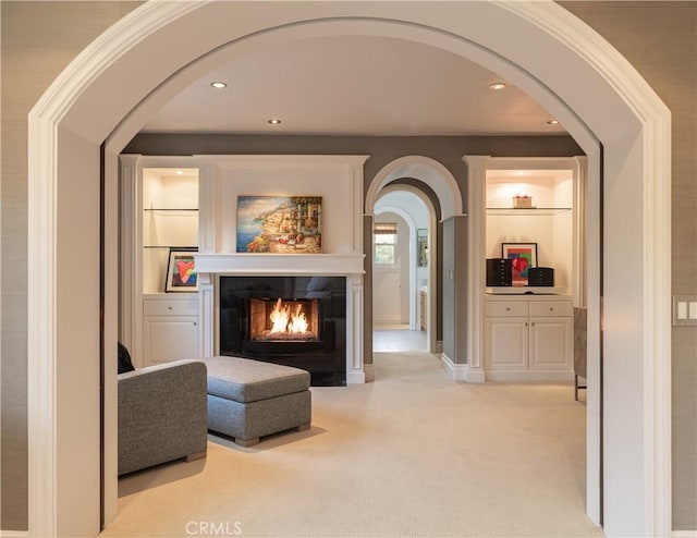 interior space featuring light carpet and built in shelves