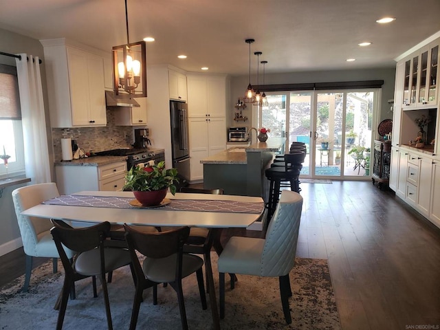 dining area featuring dark wood-type flooring