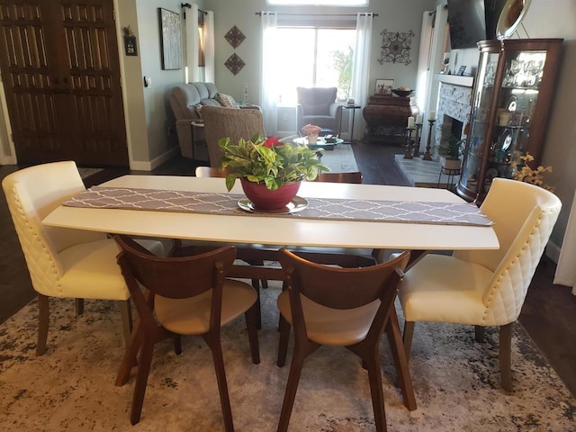 dining space featuring a stone fireplace