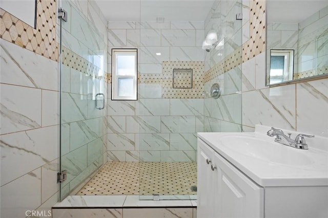 bathroom with walk in shower and vanity