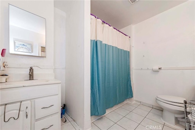 bathroom with toilet, tile patterned flooring, curtained shower, and vanity