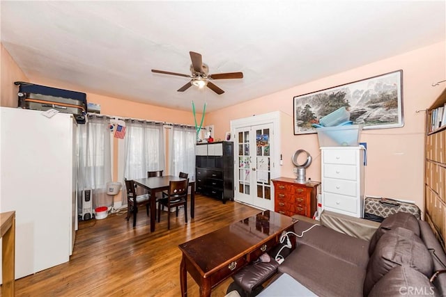 living room with french doors, wood-type flooring, and ceiling fan