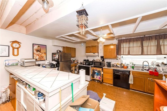 kitchen featuring stainless steel appliances, sink, ceiling fan, tasteful backsplash, and tile counters