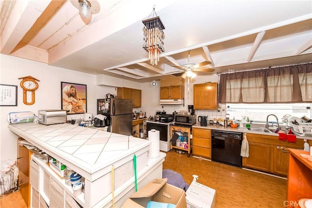 kitchen with stainless steel appliances, ceiling fan, tile countertops, decorative backsplash, and sink