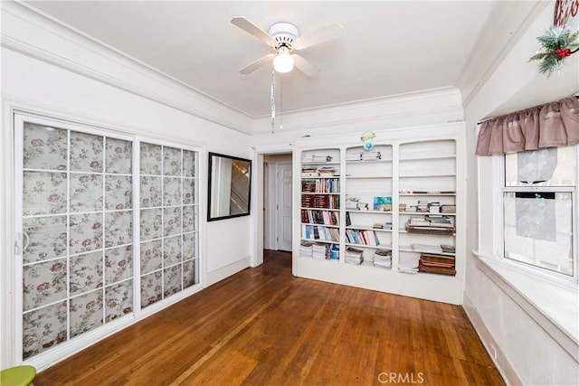 spare room featuring ornamental molding, ceiling fan, and wood-type flooring