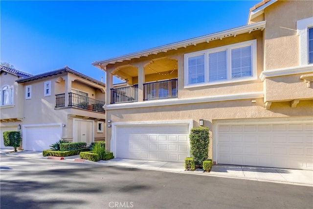 townhome / multi-family property featuring a garage and a balcony