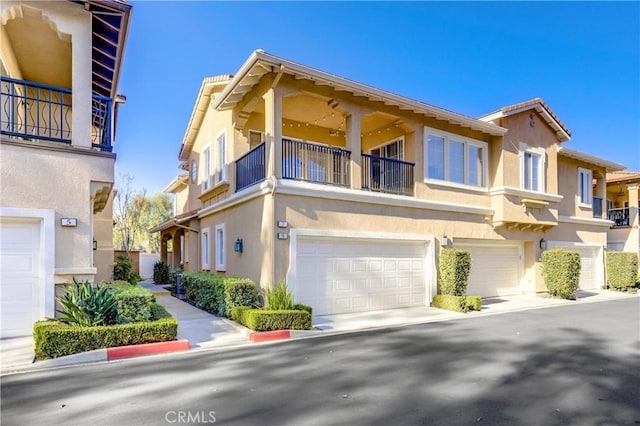 townhome / multi-family property with a balcony and a garage