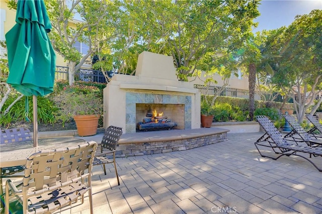 view of patio / terrace featuring a tiled fireplace