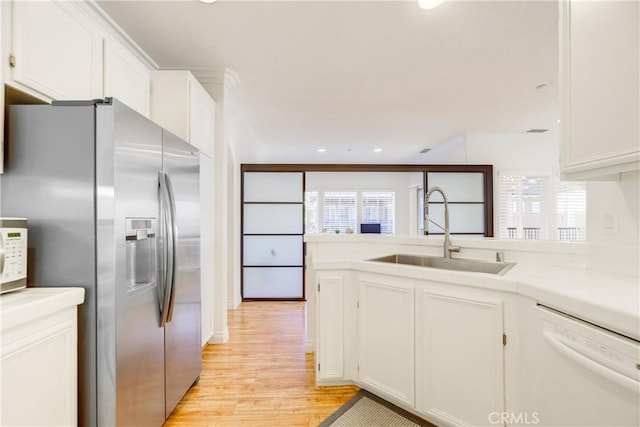 kitchen featuring white cabinets, sink, and stainless steel fridge with ice dispenser