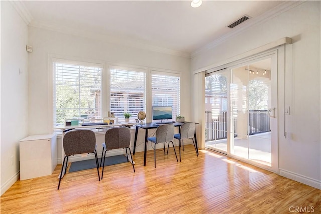 office space with light hardwood / wood-style floors and crown molding