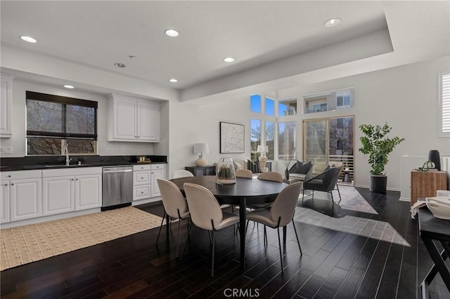 dining room with dark hardwood / wood-style flooring and sink